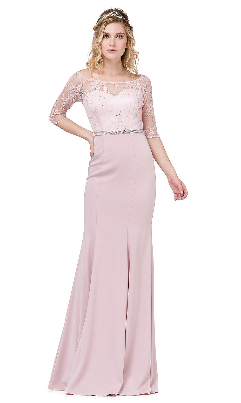A woman stands against a white background wearing the Three-Quarter-Sleeve Lace-Bodice Long Prom Dress, which features a floor-length light pink skirt and lace sleeves with a fitted lace bodice.